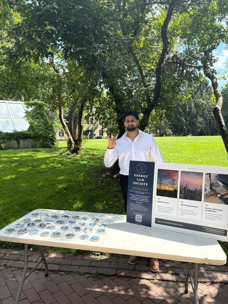 Co-President Aadam Ahmed at the Energy Law Society booth during clubs week