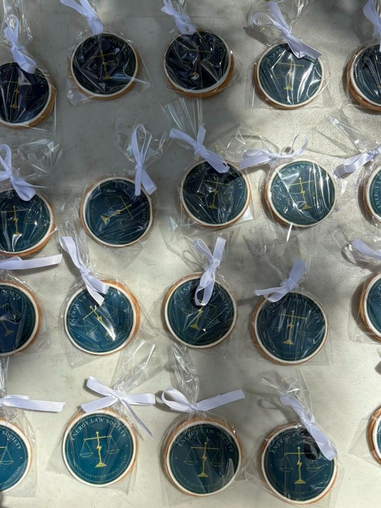 Cookies decorated with the Energy Law Society seal, individually wrapped with white ribbons